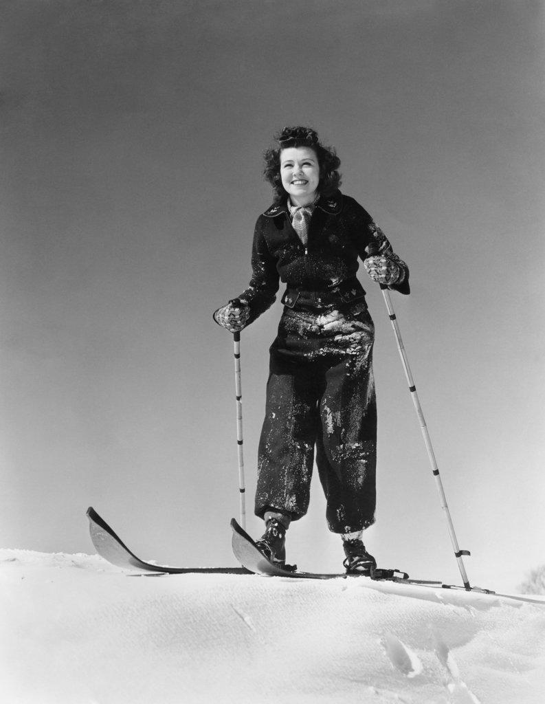 1930S 1940S Woman Smiling Standing On Wood Skis On Snow Holding Bamboo Ski Poles