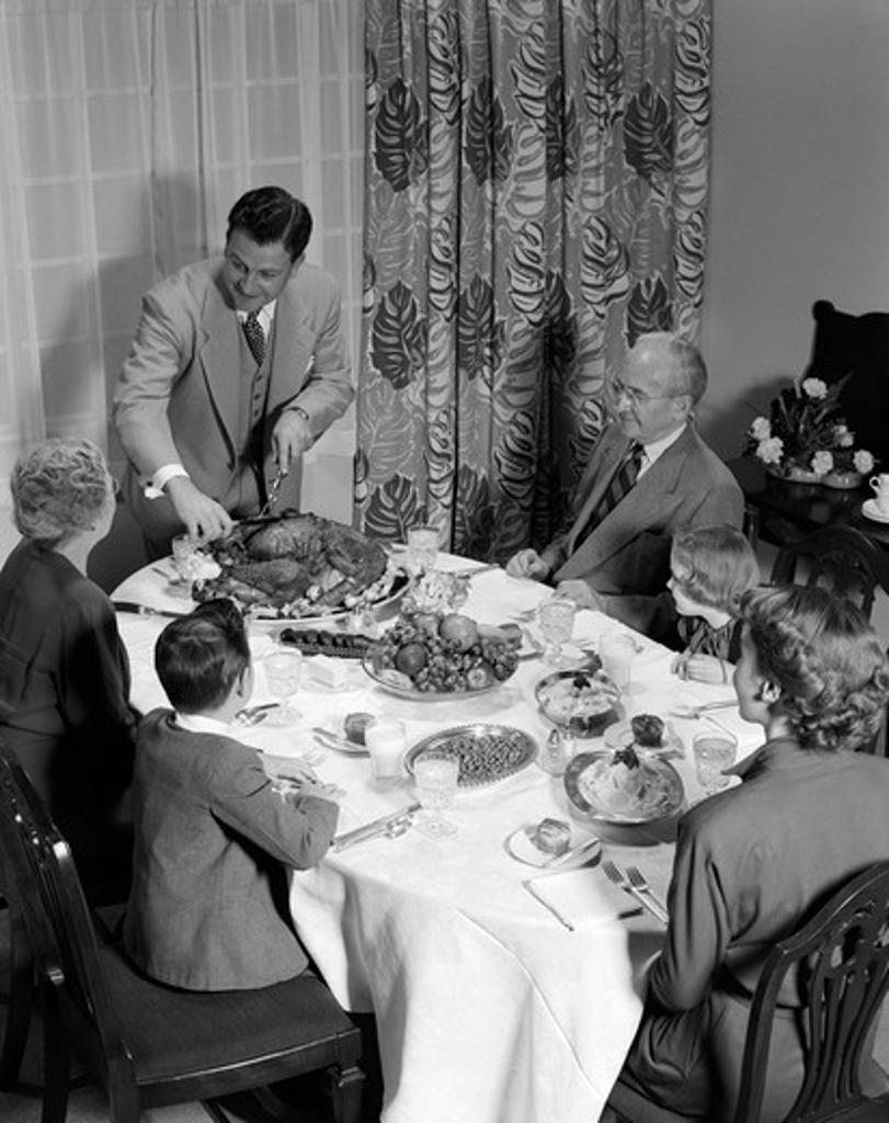 1950S 3 Generations Thanksgiving Dinner With Father Carving Turkey