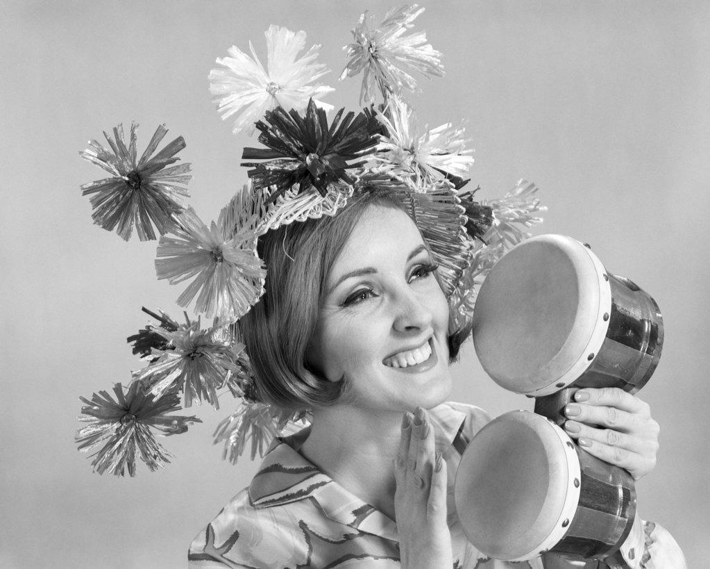 1960s SMILING WOMAN WAEARING GOOFY STRAW HAT PLAYING BONGO DRUMS