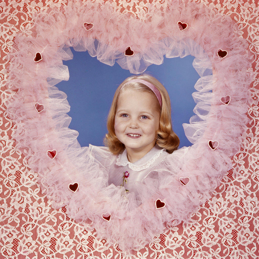 1950s 1960s SMILING BLOND GIRL POSING INSIDE A LACE VALENTINE HEART