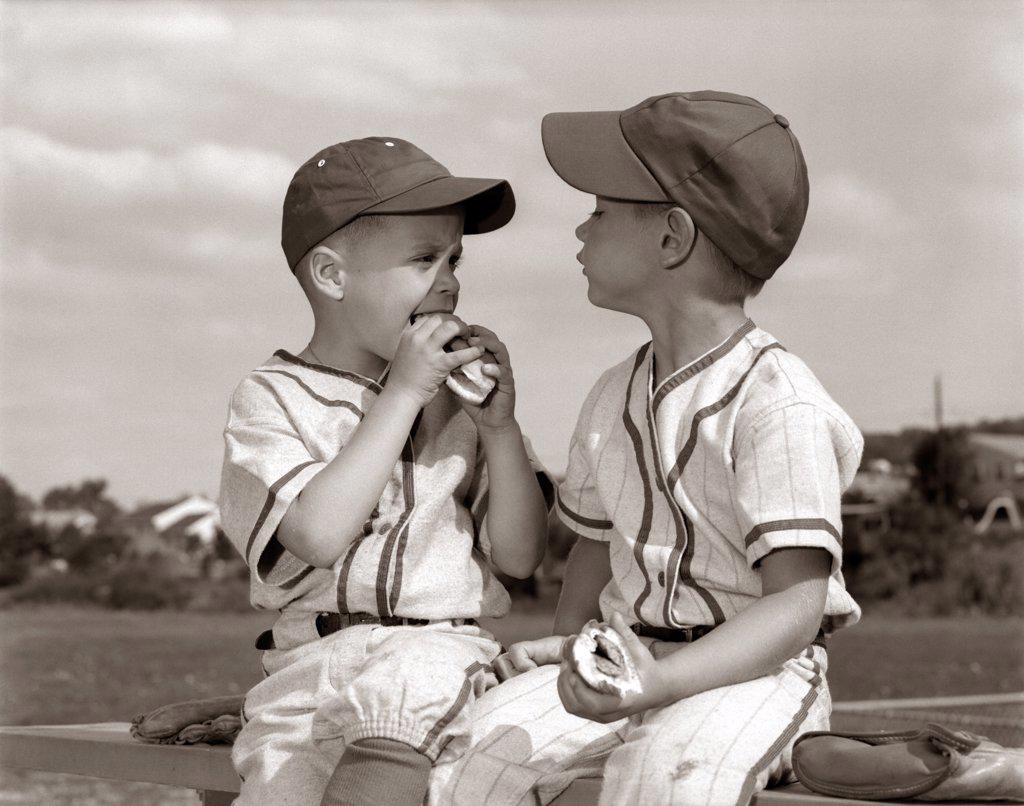 1960S Youth League Boys In Caps And Uniforms Eating Hot Dogs