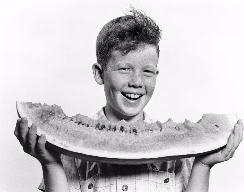 1940S 1950S Smiling Boy Holding Eating Large Slice Of Watermelon