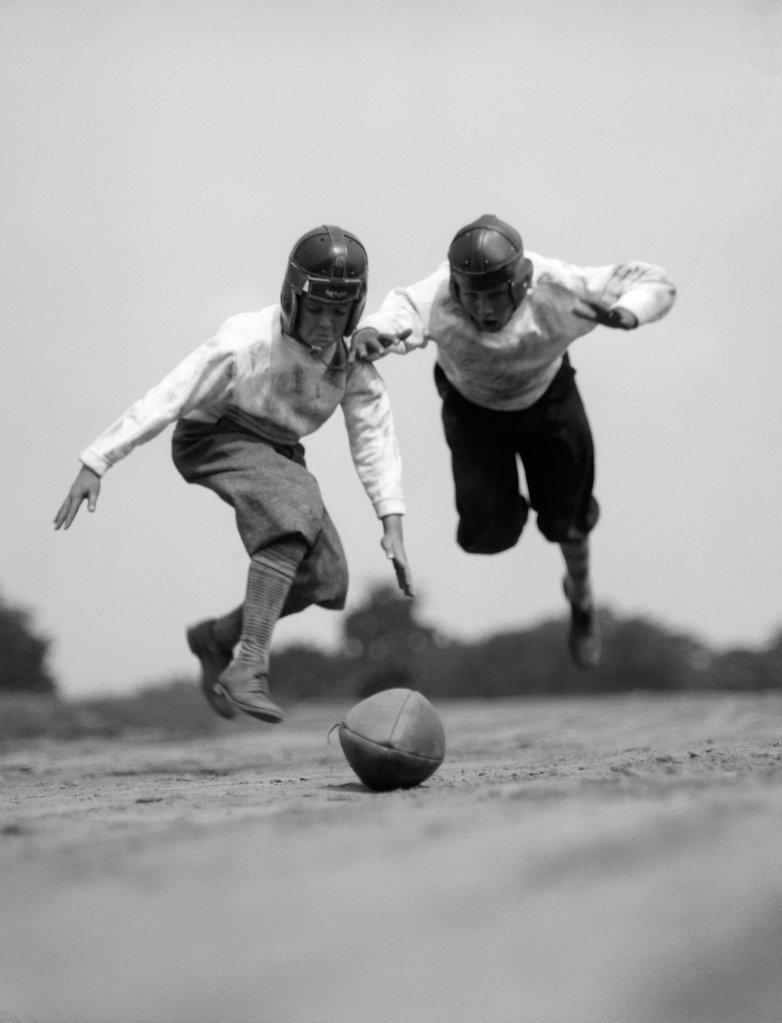1930S Pair Of Boys In Knickers & Helmets Racing To Dive On Football