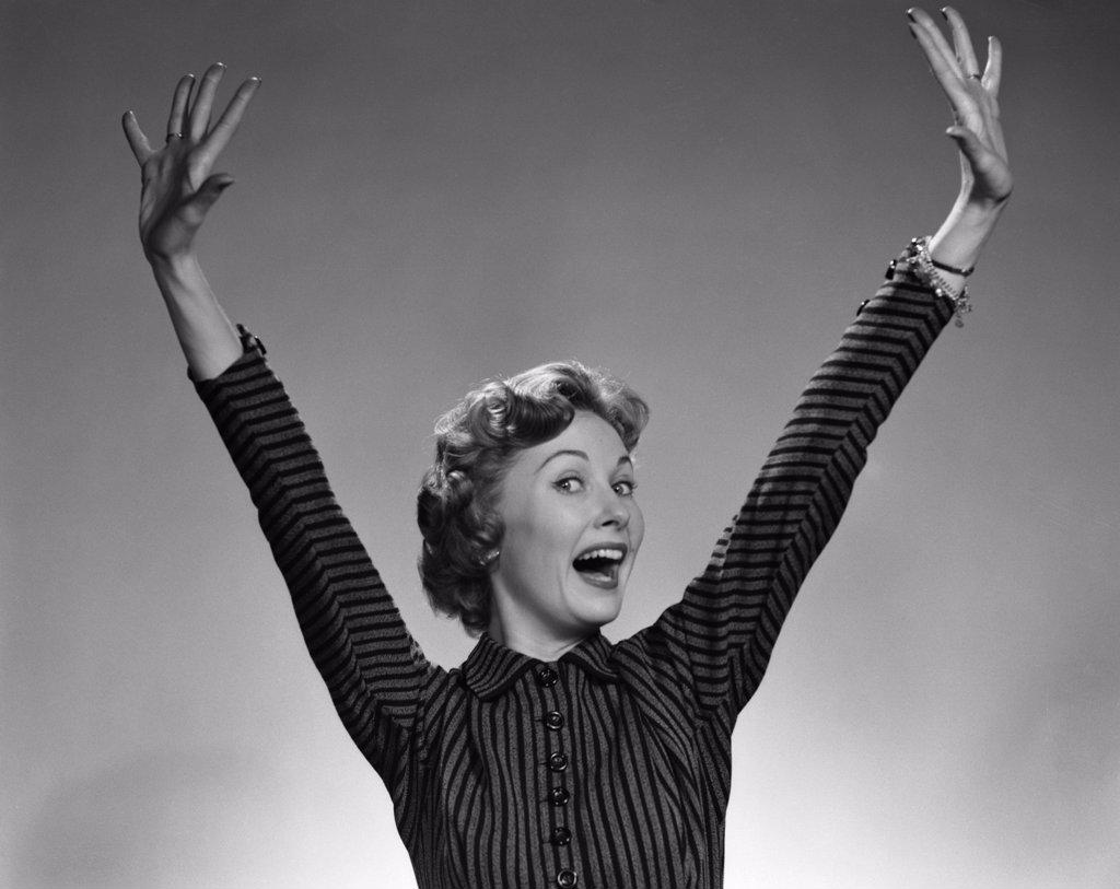 1950S 1960S Woman Smiling Wearing A Stripe Dress Extending Her Hands And Arms Above Her Head In A Happy Ecstatic Gesture Looking At Camera