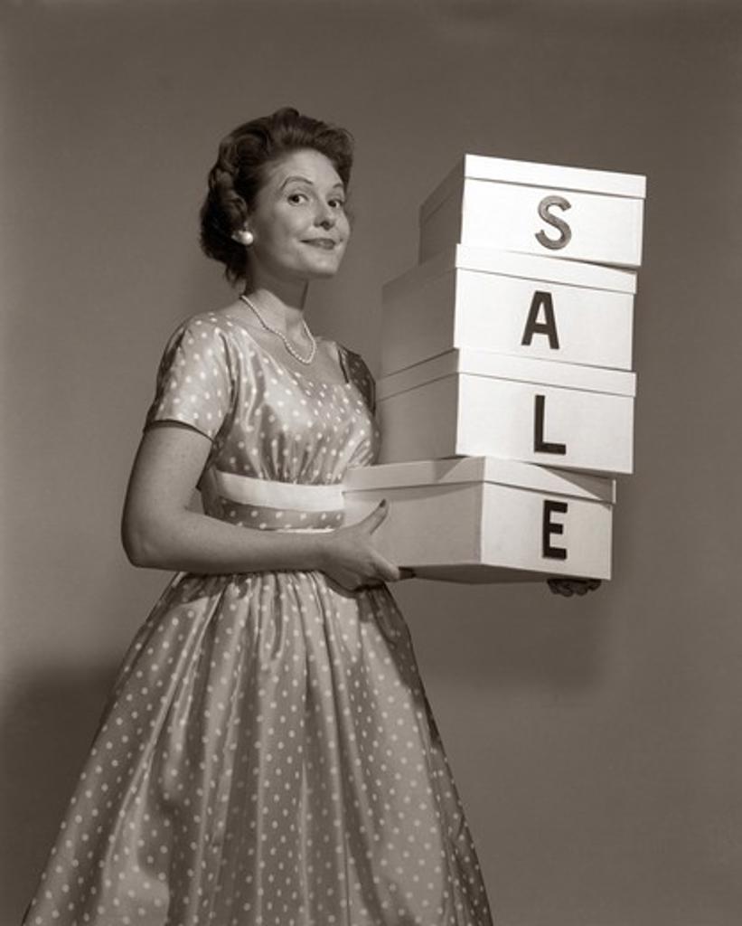 1960S Girl In Polka-Dot Dress Holding A Stack Of 4 Boxes With One Character Centered On Each Box They Are S A L E Inside