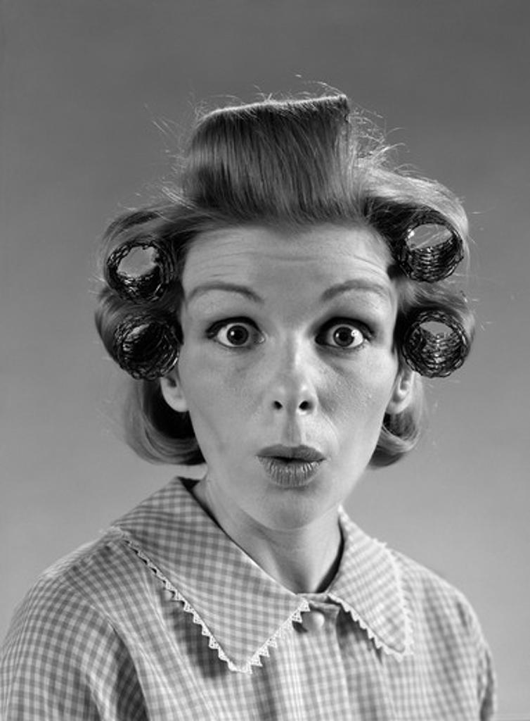 1960S Portrait Woman With Hair In Rollers Eyes Wide With Surprise