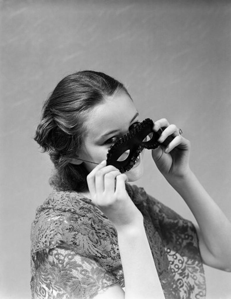 1930S 1940S Woman Putting On Taking Off Black Eye Mask