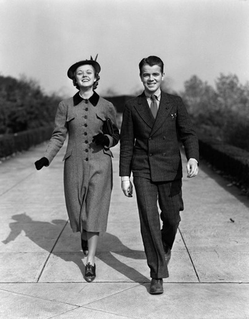 1940S Young Smiling Teenage Couple Walking On Sidewalk Smiling Dressed Up Sunday Best