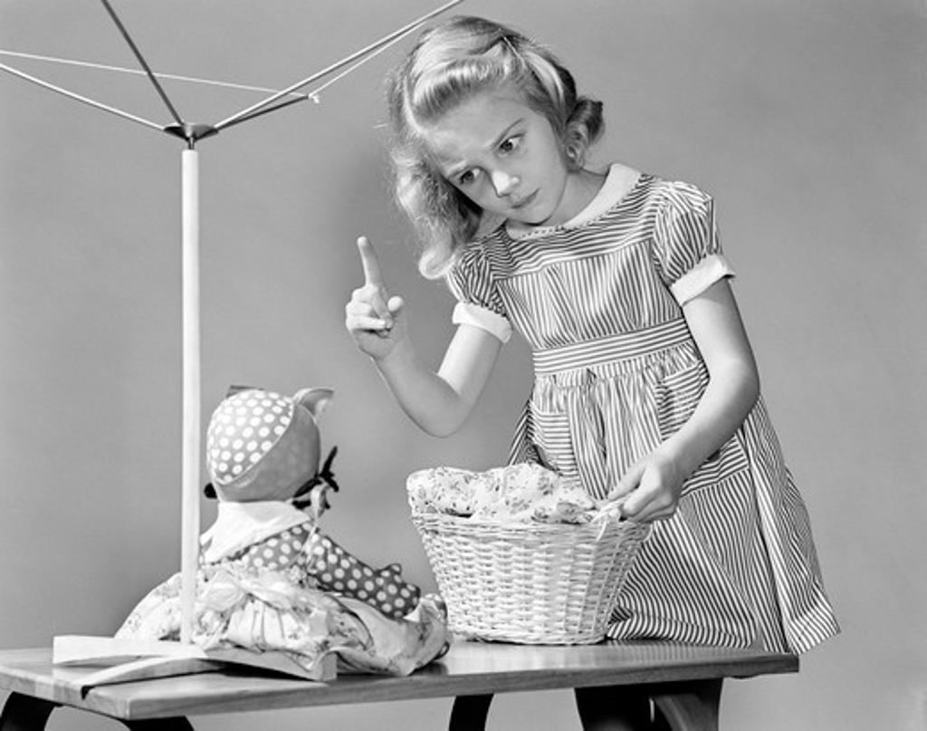 1940S Girl Shaking Her Finger At Doll Over Toy Laundry Basket