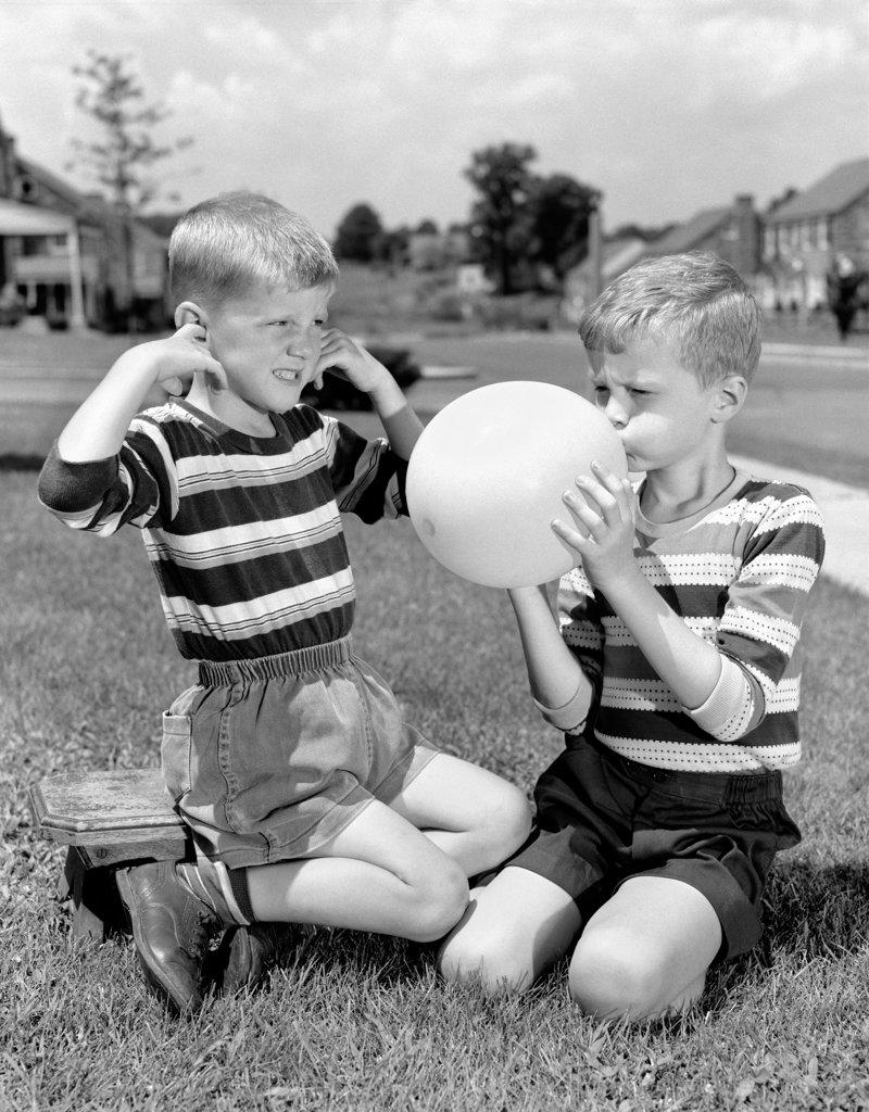 1950S Two Young Boys One Blowing Up Balloon One With Fingers In Ears Afraid Of Explosion