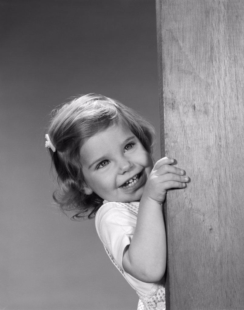 1960S Child Little Girl Smiling Peeking Around Corner