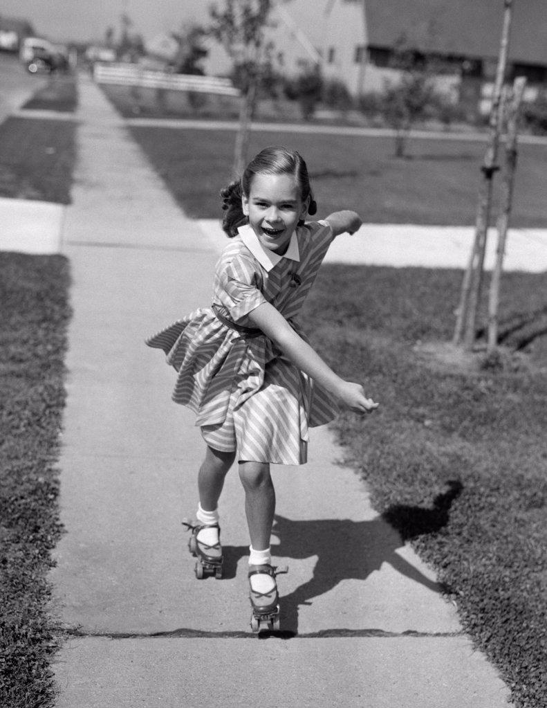 1950S Little Girl Roller-Skating On Sidewalk