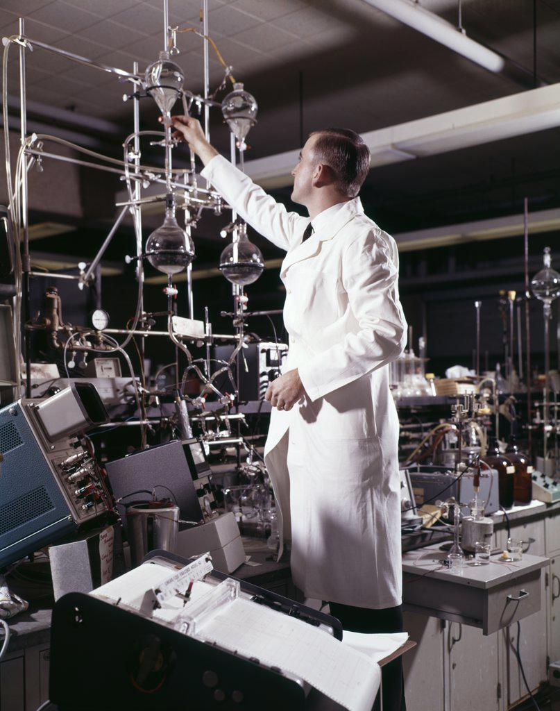 1960S Laboratory Technician Conducting A Titration Test Science Experiment Elaborate Precision