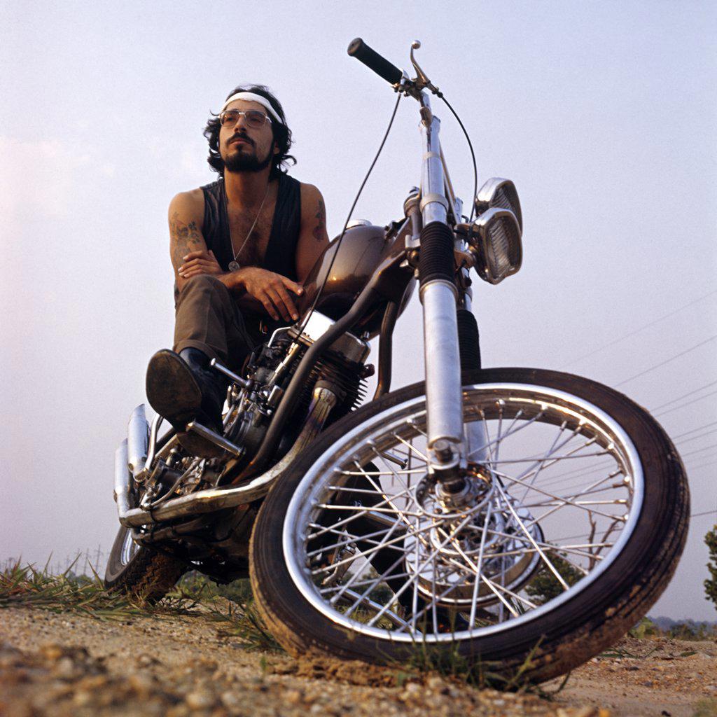 1970S Tattooed Bearded Man Sitting On Chopper Motorcycle