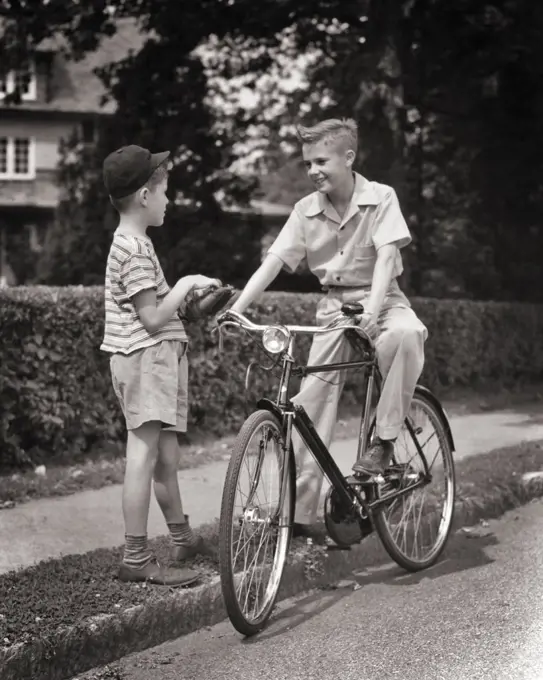 1940s TWO BOYS MEETING TALKING OLDER ONE PRETEEN SITTING ON ENGLISH STYLE BICYCLE OTHER YOUNGER HOLDING BASEBALL AND MITT