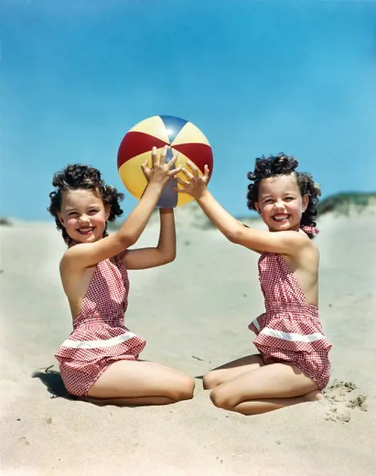 1940S 1950S Smiling Twin Girls Wearing Checkered Bathing Suits At Beach Holding Beach Ball