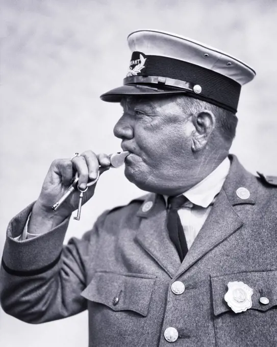 1920s 1930s TRAFFIC POLICEMAN BLOWING WHISTLE WEARING UNIFORM