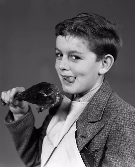 1940S Portrait Of Boy With Napkin Bib And Turkey Leg Smiling At Camera