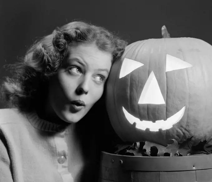 1940S Teen Girl Look Scared Head To Head With Carved Pumpkin Jack-O-Lantern