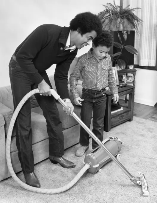 1970S 1980S African American Man Father And Son Boy Vacuuming Carpet Vacuum