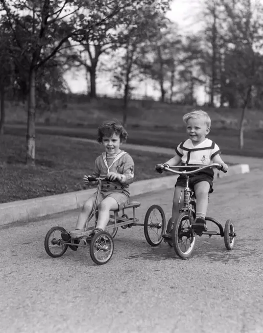1930S Two Smiling Boys Riding Tricycles