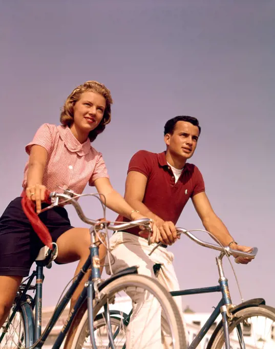 1950S 1960S Couple Man Woman Riding Bicycles Outdoors