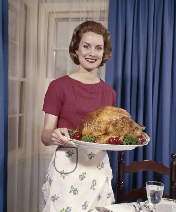 1960S Smiling Woman Serving Thanksgiving Turkey Dinner