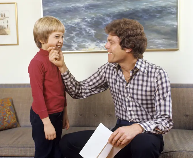 1970S Father And Son Laughing Talking Touching Couch Man Boy