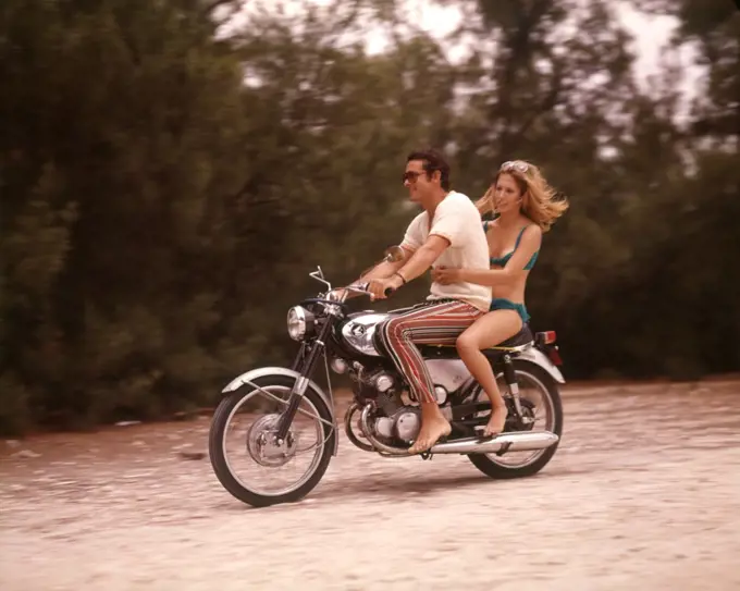 1970S Barefoot Couple Man Woman Wearing Beach Clothing Riding Motorcycle