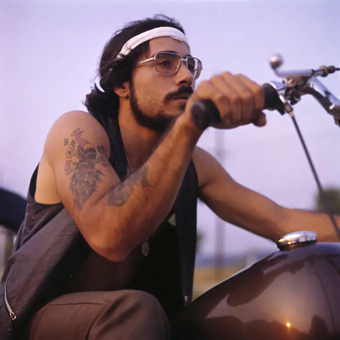 1970S Retro Man Motorcycle Easy Rider With Headband Tattoos Mustache Beard Wire Frame Glasses
