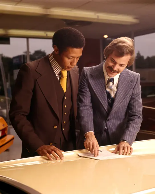 1970S Two Men Read Papers Document Contract Hood Of New Car Sales Showroom Dealer Dealership Customer Salesman