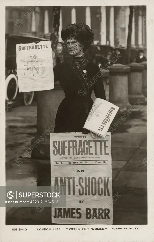 London Life - A Rotary Postcard photograph showing a suffragette selling copies of 'The Suffragette paper - October, 1912. The woman in the image is wearing a Holloway brooch, a brooch of honour designed by Sylvia Pankhurst for women who had been imprisoned in Holloway Prison. The brooch shows a portcullis symbol of the House of commons, the gate and hanging chains in silver and the superimposed broad arrow in purple, white and green enamel. The newsletter The Suffragette was published by the Wo