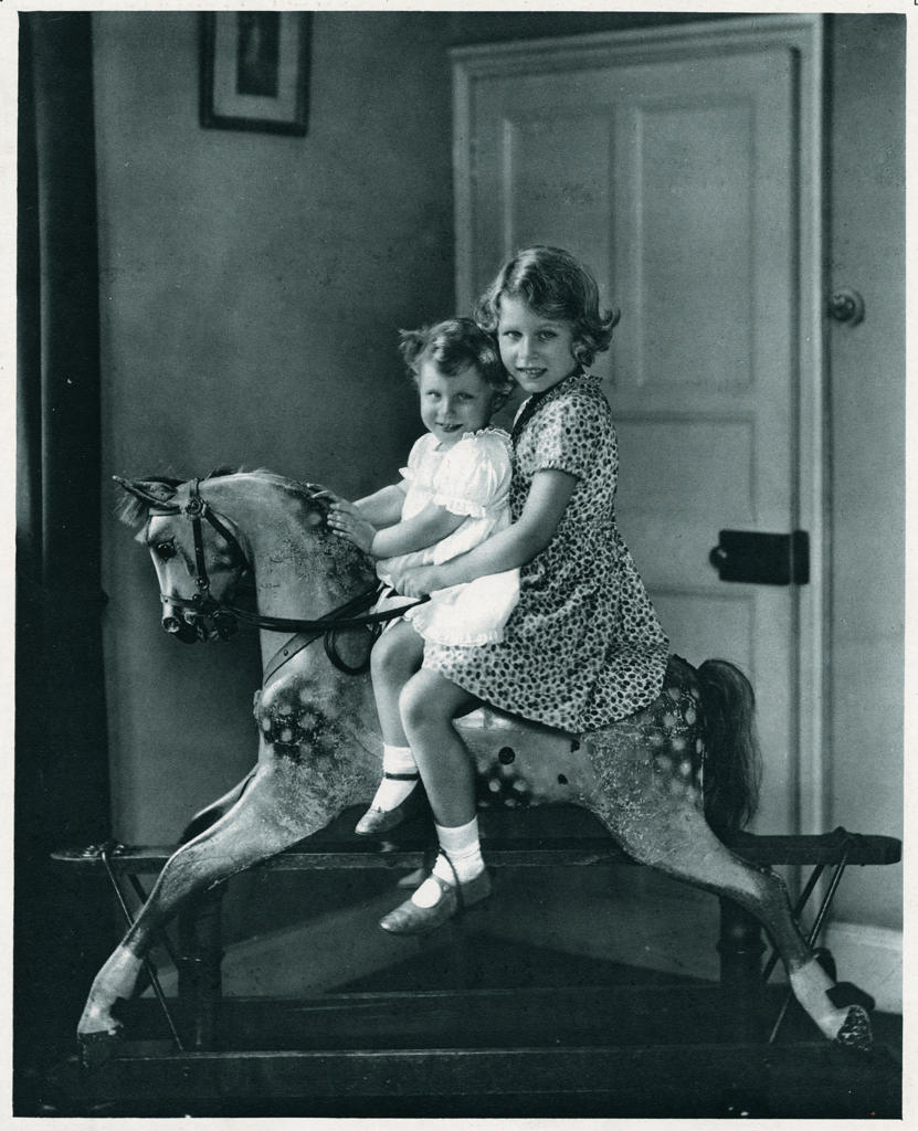 Princess Elizabeth and Princess Margaret photographed on a rocking horse.     Date: 1937