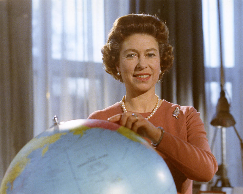 Portrait of Queen Elizabeth in December 1970, standing by a globe.       Date: 1970