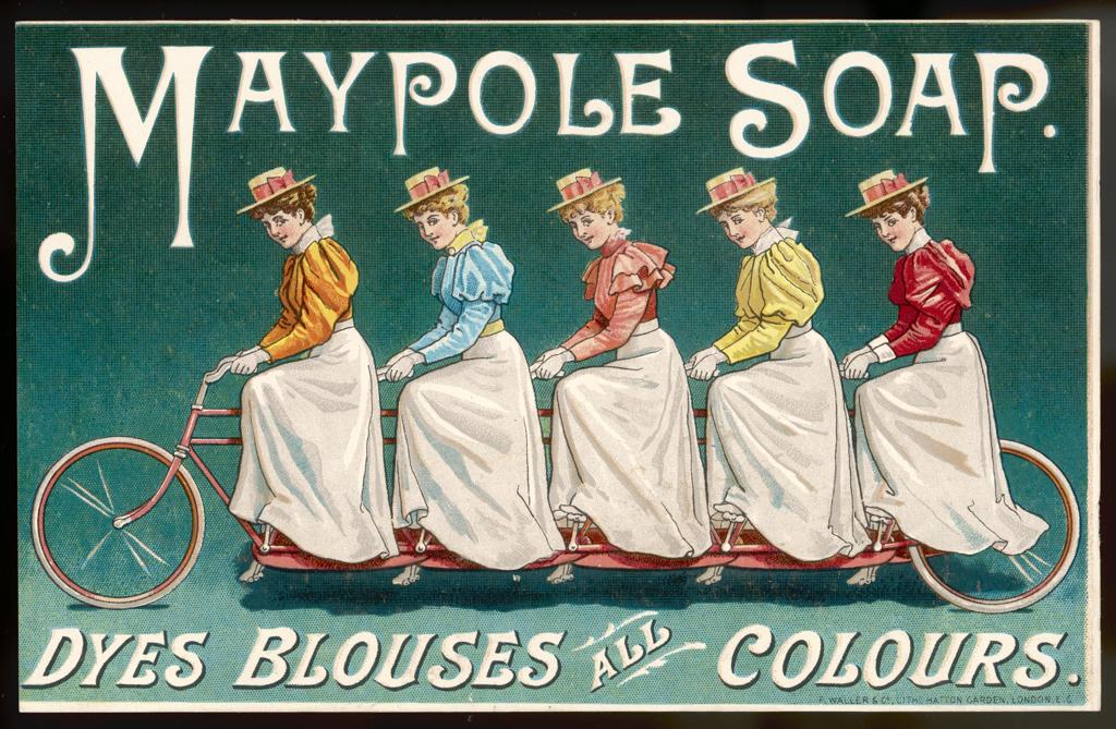 Ladies in coloured shirts on a  bicycle display the range of  Maypole soap dyes   