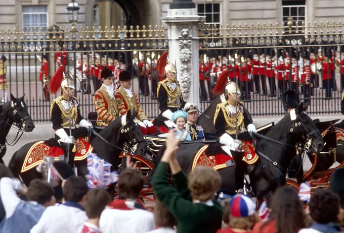 Crowds lining the route from Buckingham Palace to St Paul's Cathedral on the day of the Royal Wedding between Prince Charles and Lady Diana Spencer on 29 July 1981, cheer the Queen and Prince Philip as they pass in a carriage.     Date: 1981