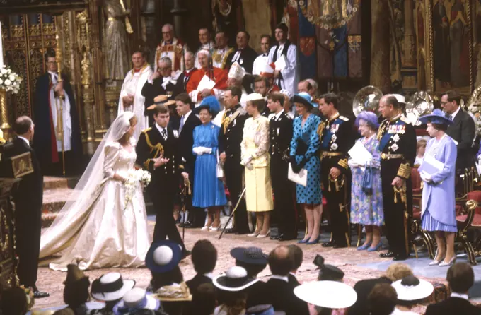 A newly married Prince Andrew, Duke of York and Lady Sarah Ferguson, Duchess of York walk from the altar in front of prominent members of the royal family after their marriage service in Westminster Abbey on 23 July 1986.     Date: 1986
