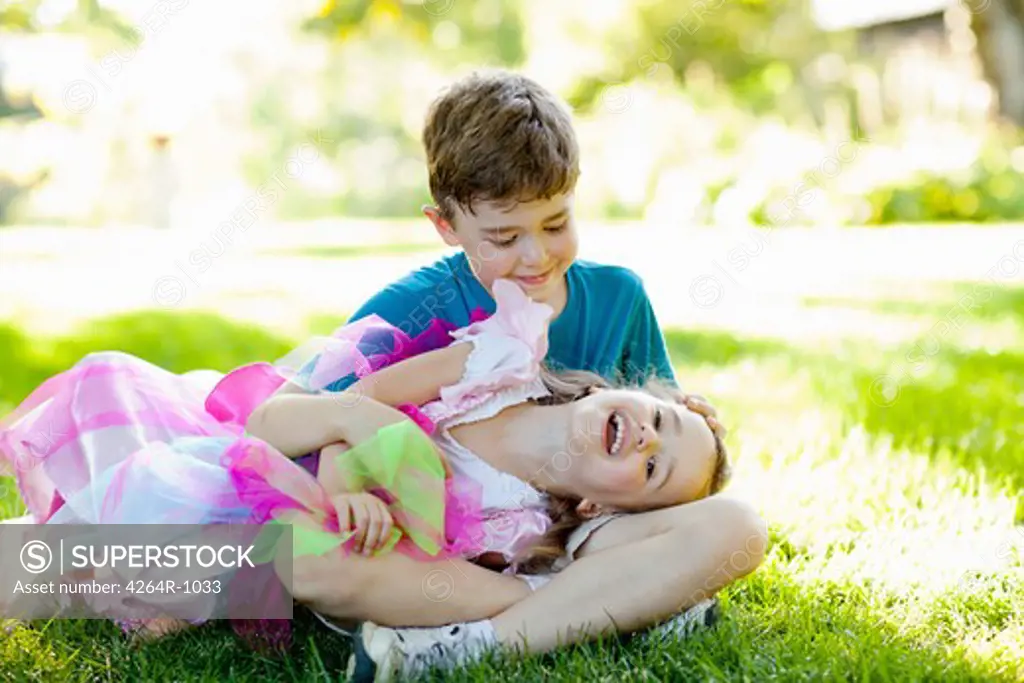 Portrait of brother and sister playing in garden
