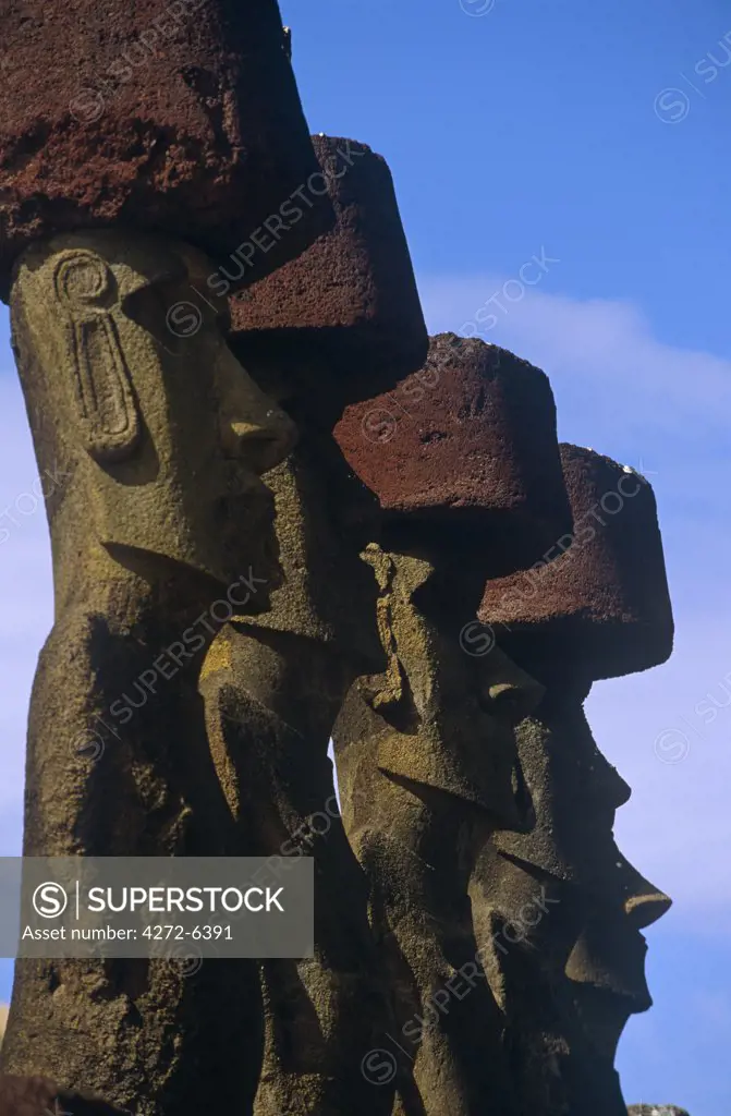 Chile, Easter Island, Anakena. Ahu Nau Nau, the standing Moai statues topped with red scoria headdresses (known as Pukao).