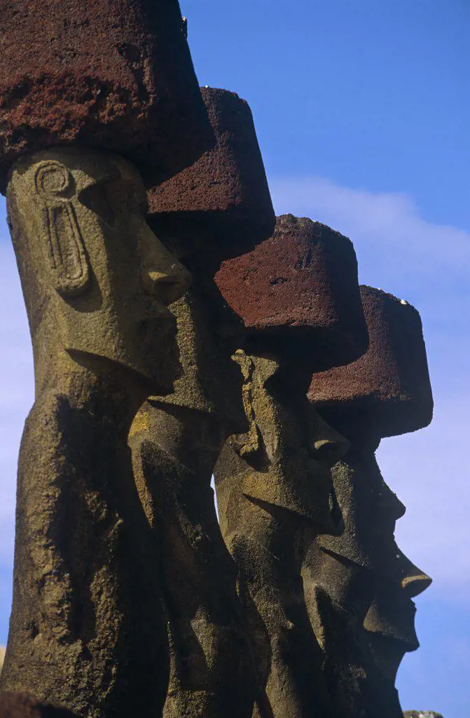 Chile, Easter Island, Anakena. Ahu Nau Nau, the standing Moai statues topped with red scoria headdresses (known as Pukao).