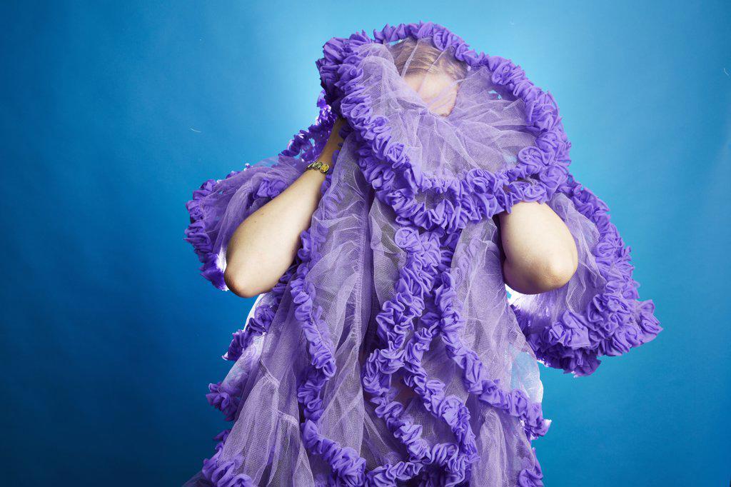 Woman Covering her Face with Ruffle Skirt