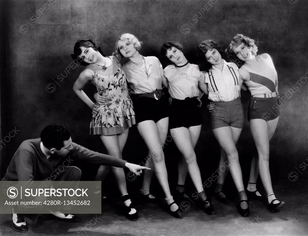 Dance instructor instructing five young women All persons depicted are not longer living and no estate exists Supplier warranties that there will be n...