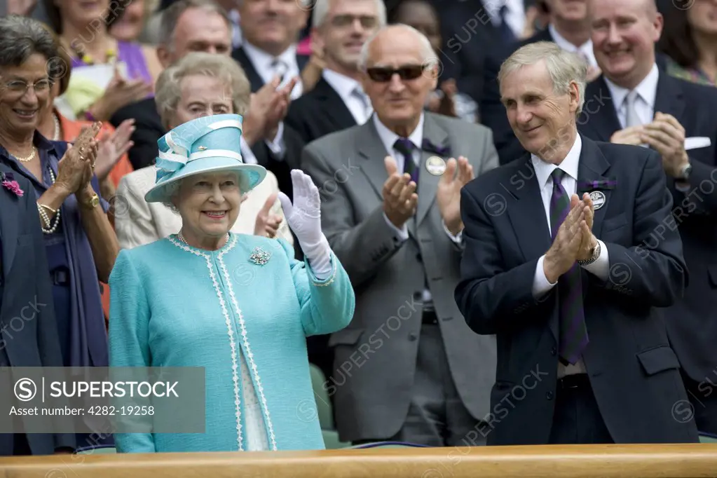 England, London, Wimbledon. HRH Queen Elizabeth II waves to the crowd from the royal box during the Wimbledon Tennis Championships 2010.