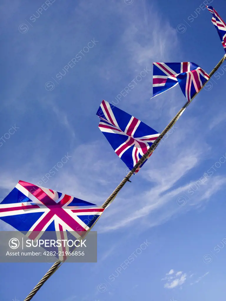 British Union Jack flags against a blue sky.