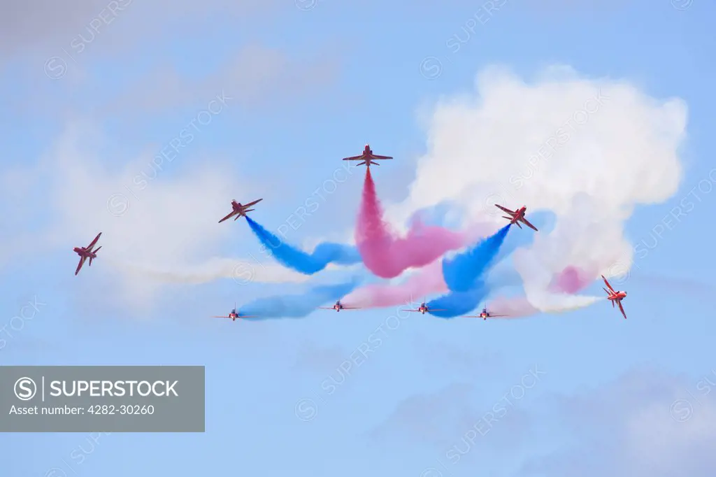 England, Gloucestershire, Fairford. The Red Arrows team breaking from formation at the Royal International Air Tattoo at RAF Fairford 2011.