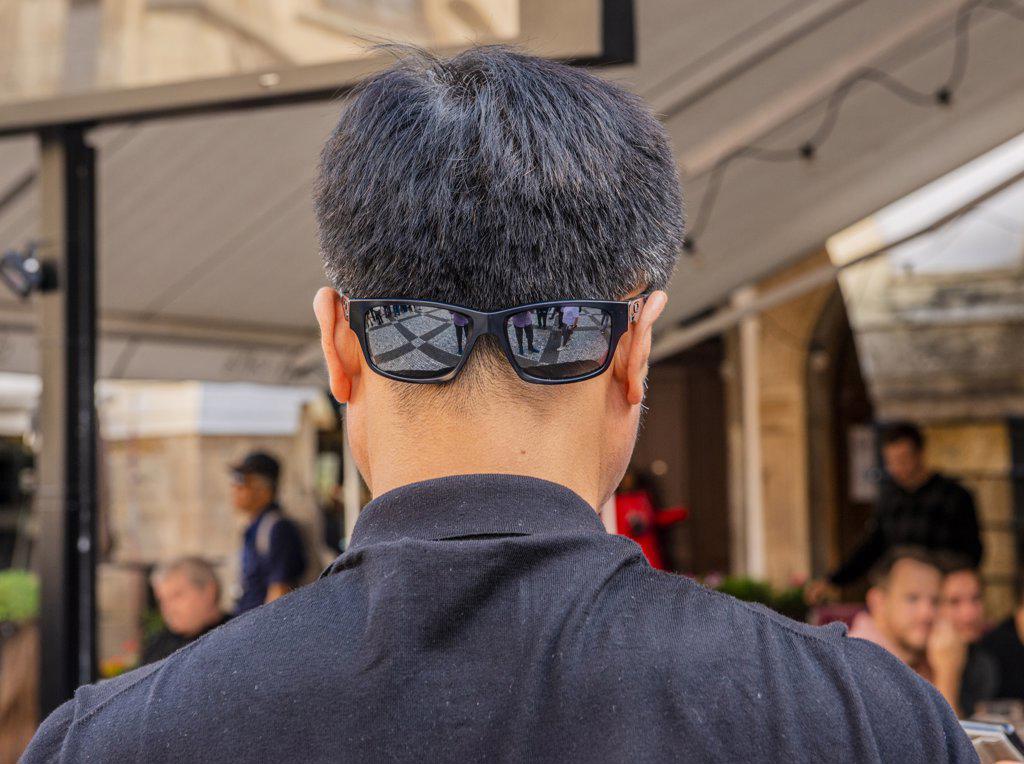 Man wearing sunglasses on back of head in Prague in the Czech Republic.