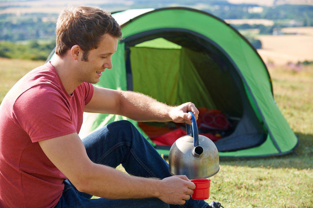Young Man Camping In The Countryside
