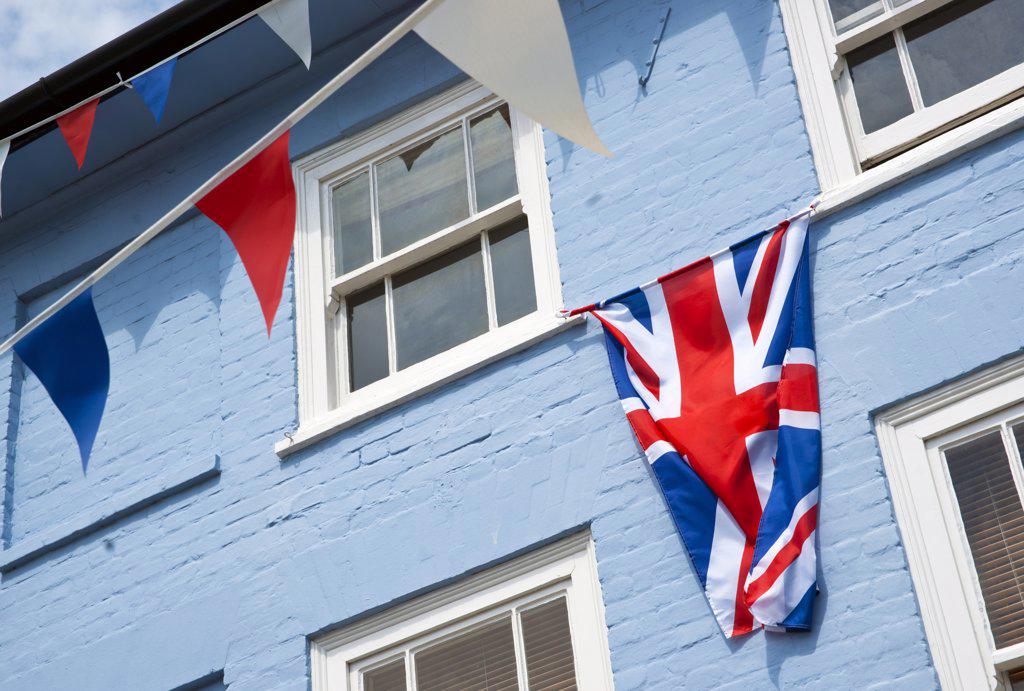 England, Essex, Thaxted. A Union flag and bunting on the front of a house in Thaxted.