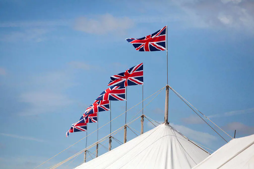 England, West Sussex, Goodwood. A series of Union Jack flags on top of a marquee at Goodwood revival.