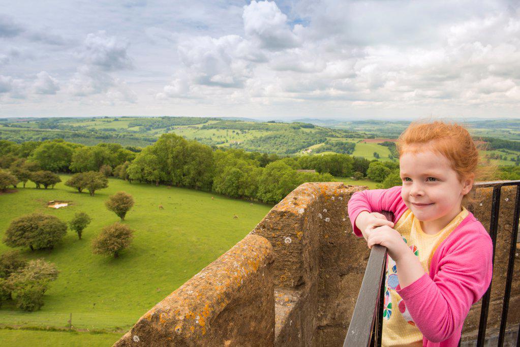 England, The Cotswolds, Broadway Hill. A little girl enjoys the views from Broadway Tower in The Cotswolds.